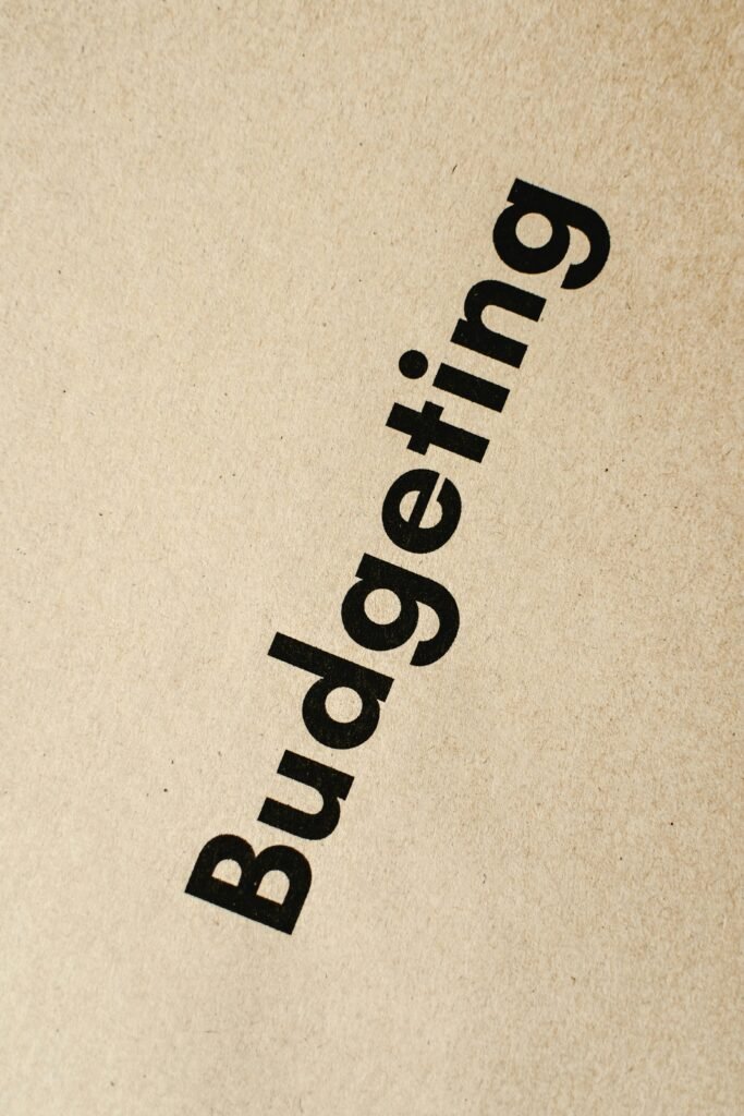 Detailed close-up of the word 'Budgeting' printed on brown textured paper.